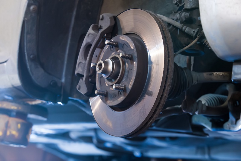 Certified mechanic performing brake service at Alpine Auto Group